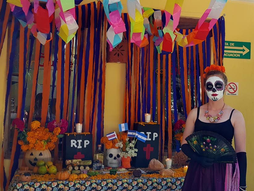 Catrina at ofrenda on Dia de Muertos