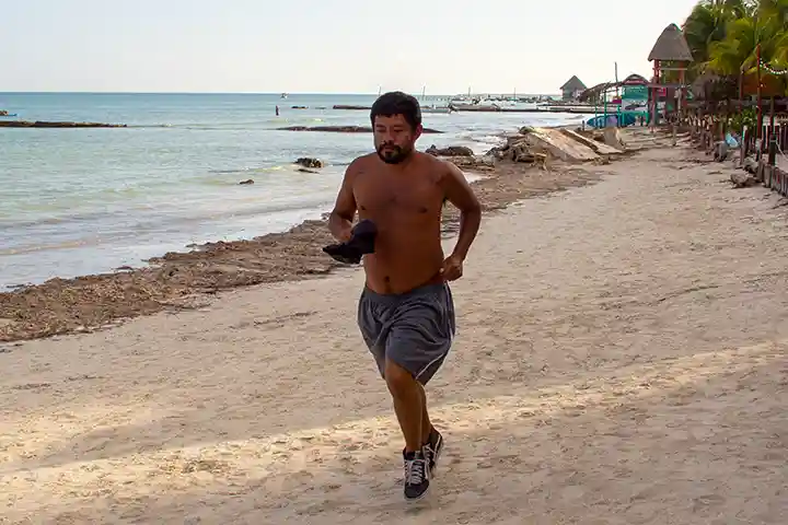 A jogger runs along the beach on Holbox Island