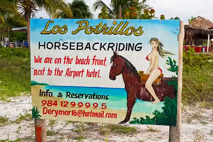 Los Potrillos sign for horseback riding tours on Holbox Island