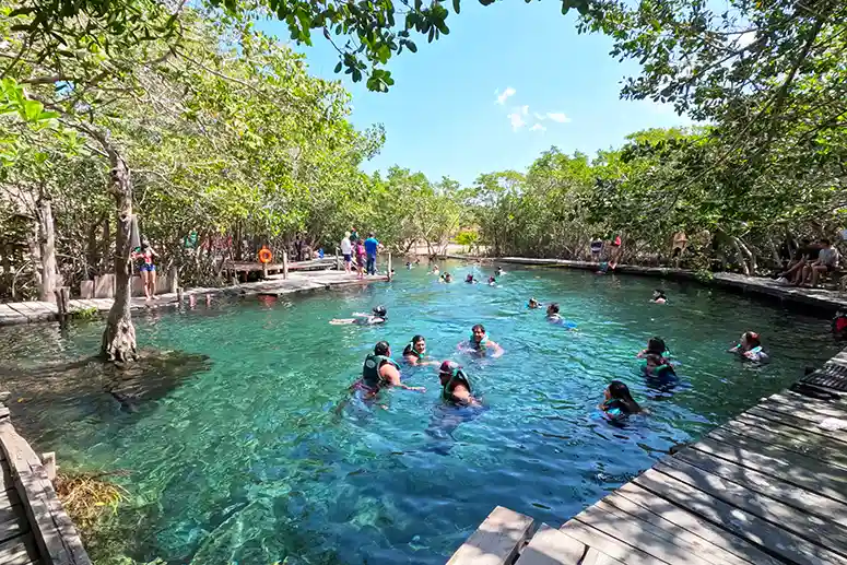 Bathers in Yalahau Cenote with border