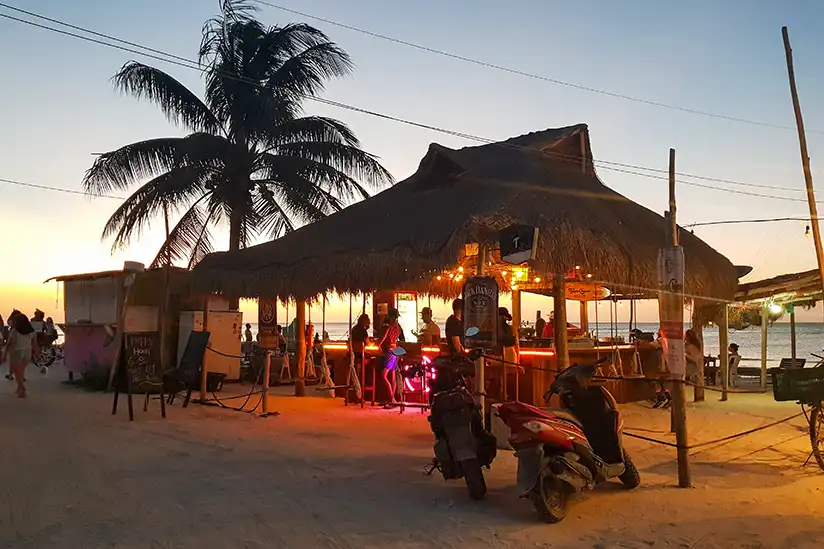 Motorcycle in front of the Bikini Bottom beach bar as the sun sets and the Holbox nightlife begins.