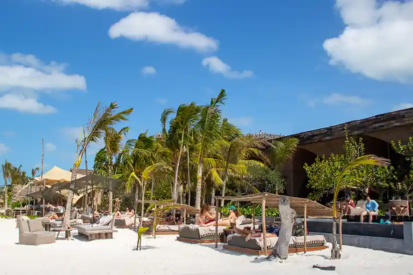 Beach area with sun loungers at the Nômade Temple Holbox Hotel.