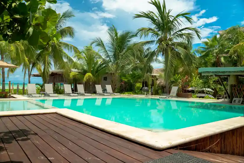 Pool with sun loungers at the Holbox luxury hotel Villas Caracol.