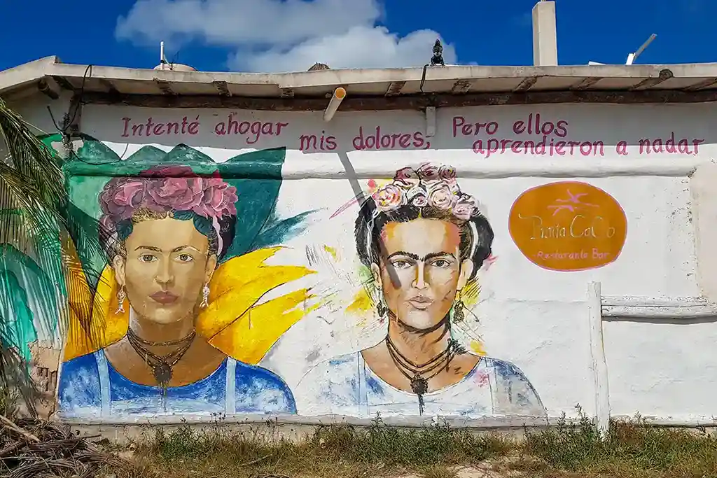 Street art mural of Frida Kahlo with flower crowns near Punta Cocos on Isla Holbox.