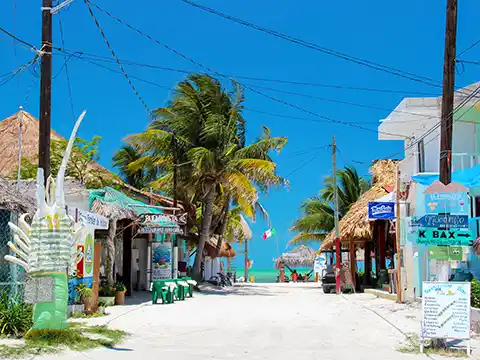 Sandy street invites to explore Holbox Island by bike or golf cart.