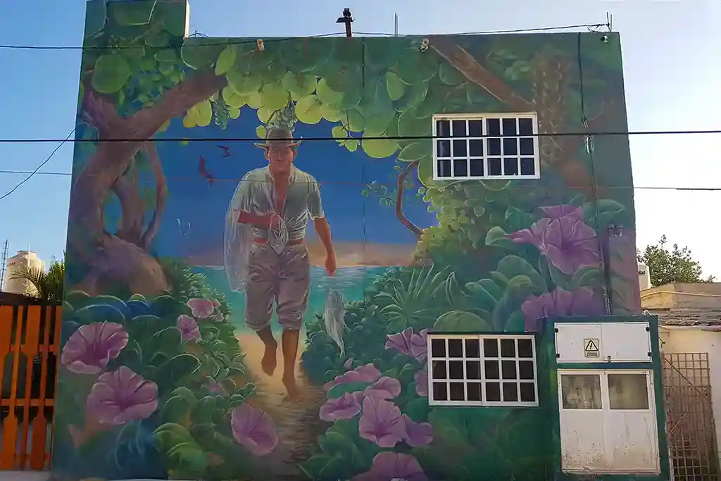 Street art depicting a local fisherman with his catch and a fishing rod on Isla Holbox.