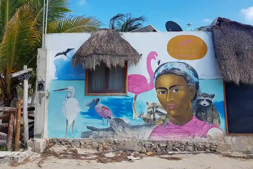 Detailed wall painting of Holbox wildlife including a flamingo, heron, and iguana.