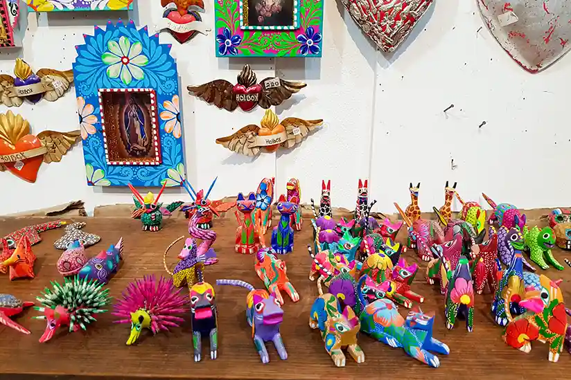 Colorful hand-painted Mexican Alebrijes wood carvings on display at a local craft shop in Holbox.